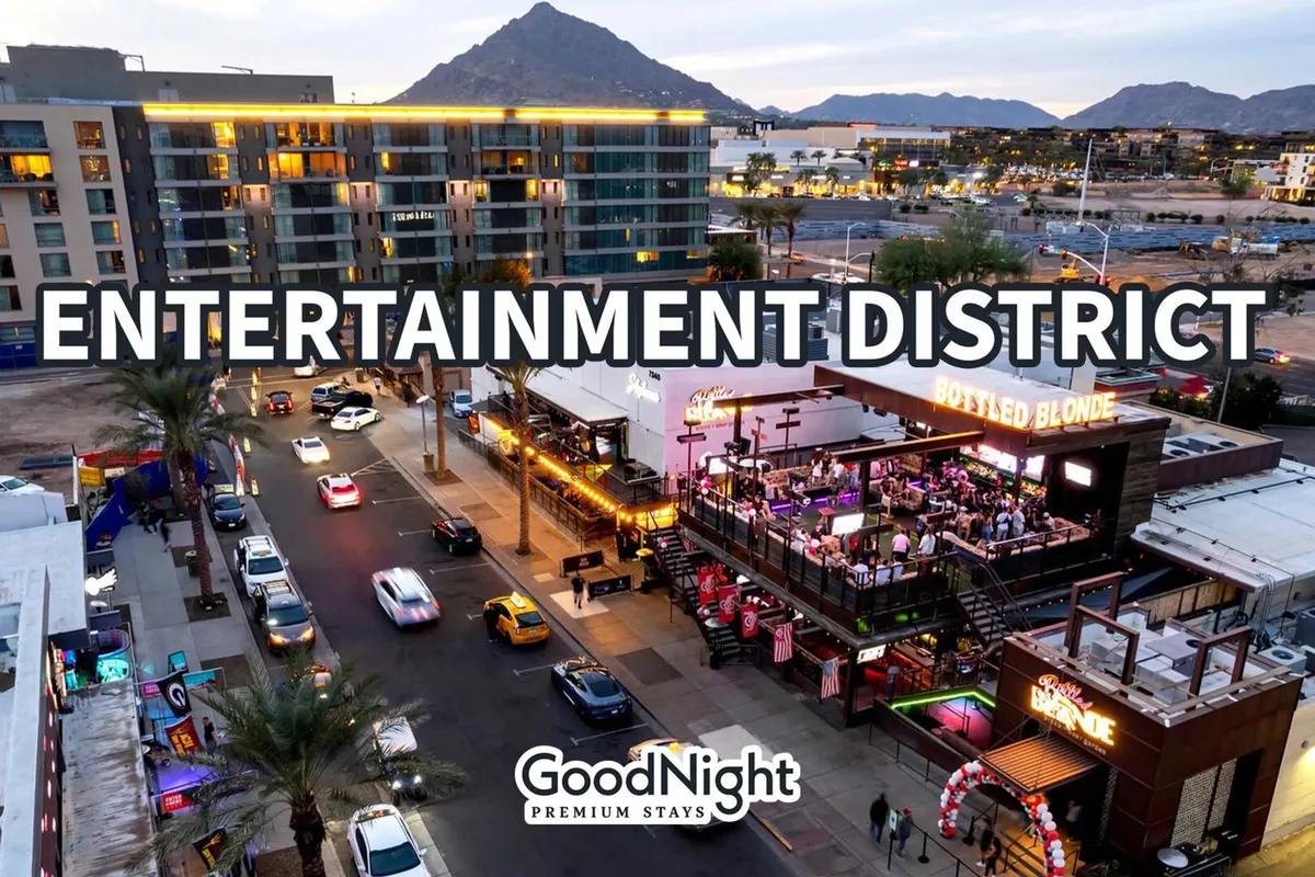 A street-level shot of the entertainment district featuring signage for Bottled Blonde, cars cruising by, and a mountainous backdrop. The image captures the lively vibe of Old Town’s main strips, teeming with people headed to restaurants, music venues, and shops.