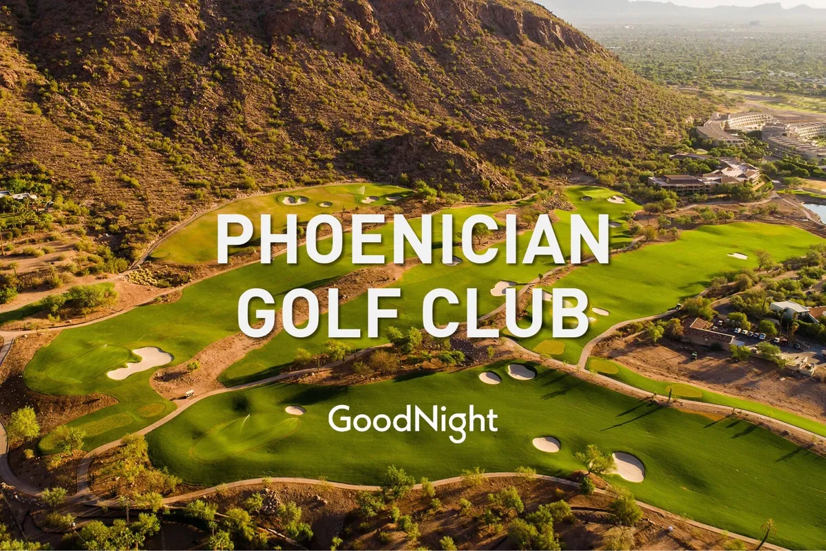 A vibrant golf course green unfolds towards a mountain backdrop, with a water hazard and the clubhouse visible. The setting sun casts a warm glow, inviting relaxation and social occasions in a picturesque desert setting.